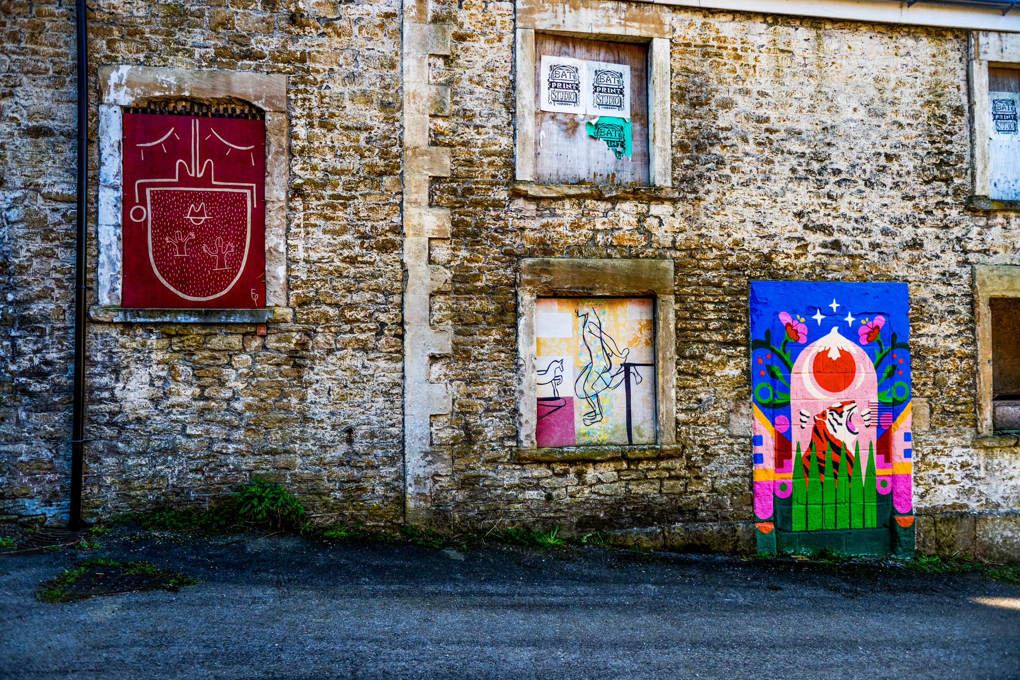 Colourful street art painted on the stone walls near Silk Mill Studios in Frome.
