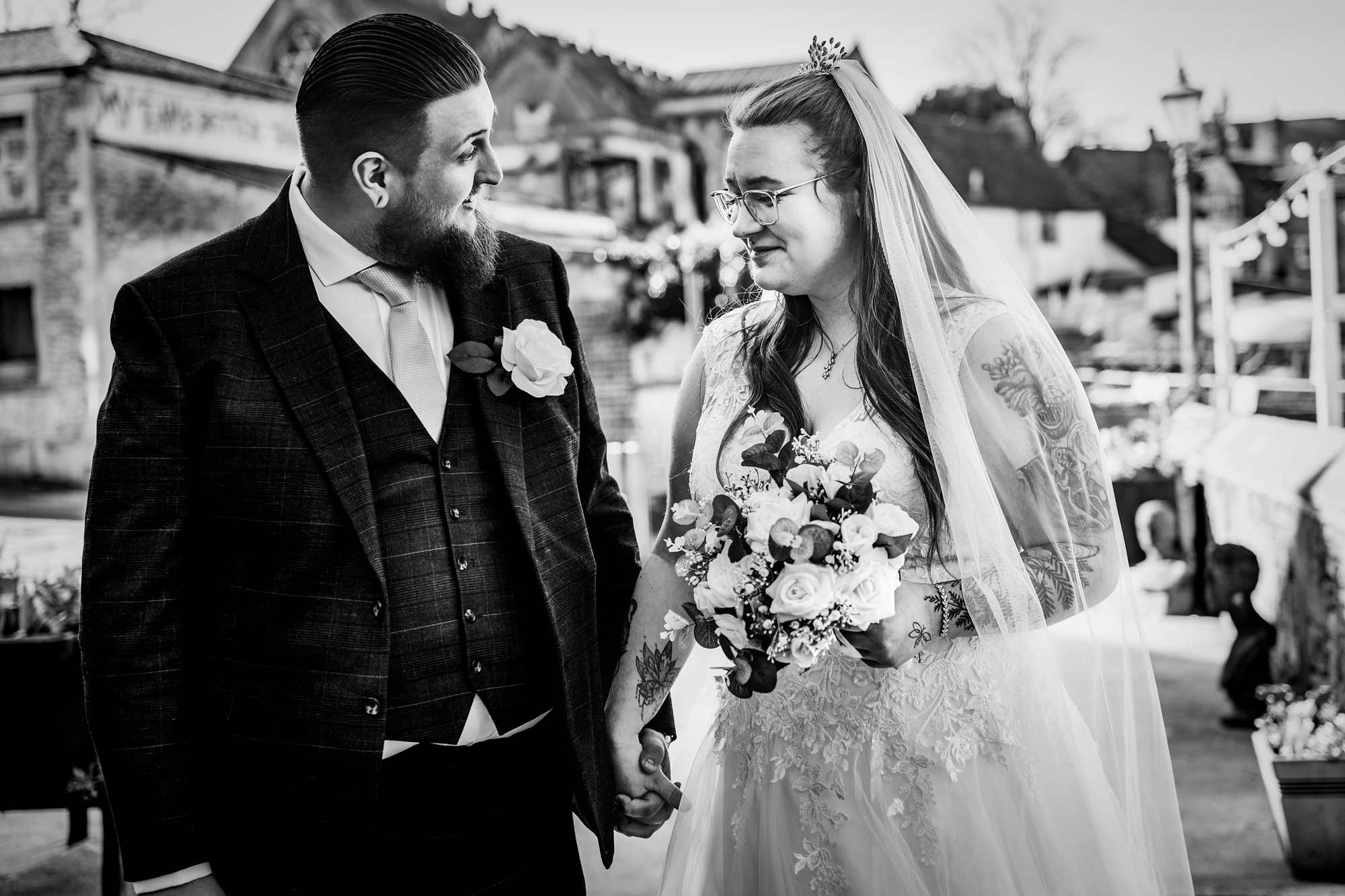 Nat and Jon look at each other while holding hands outside Silk Mill Studios in Frome.