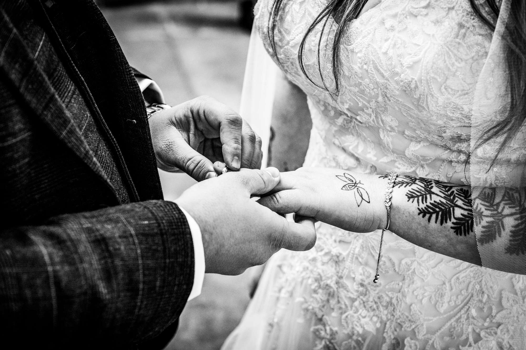 Jon slides Nat’s ring onto her hand as guests watch from their seats.
