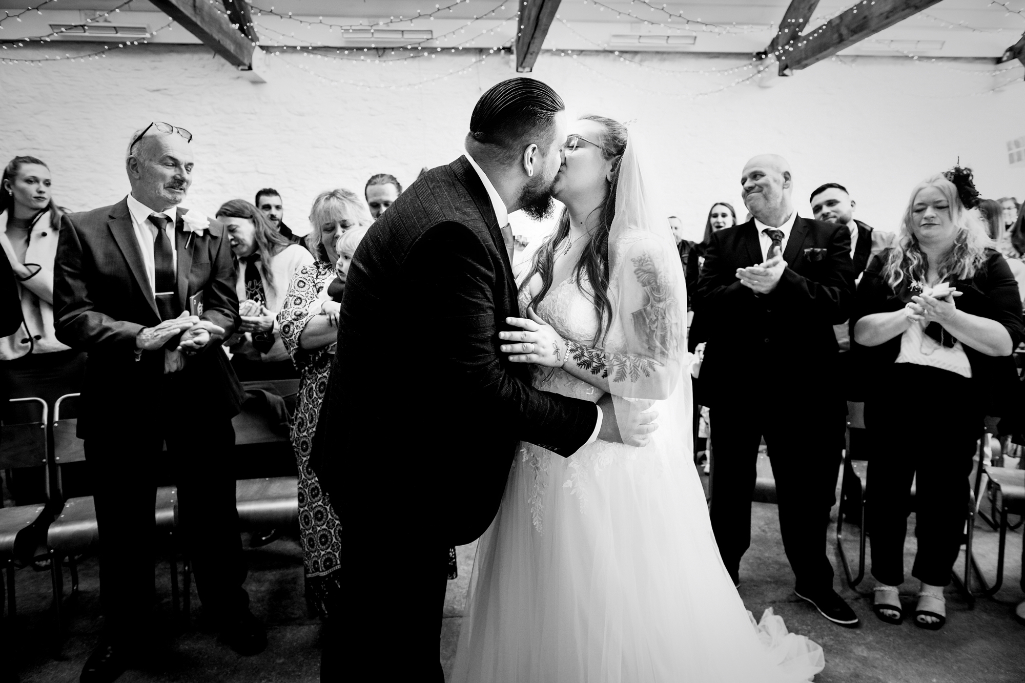 Nat and Jon share their first kiss as guests applaud inside Silk Mill Studios.