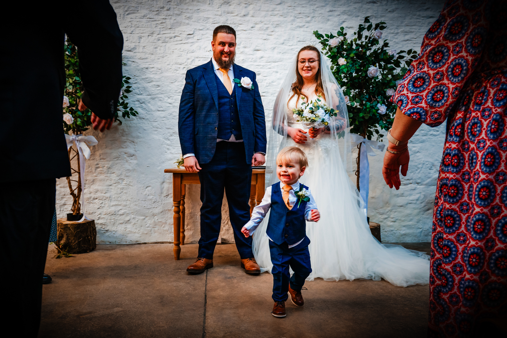 Theo runs toward Nat and Jon during a family photo after the ceremony.