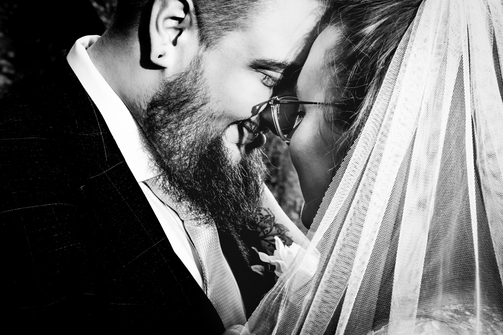 Close-up of Nat and Jon touching foreheads outdoors.