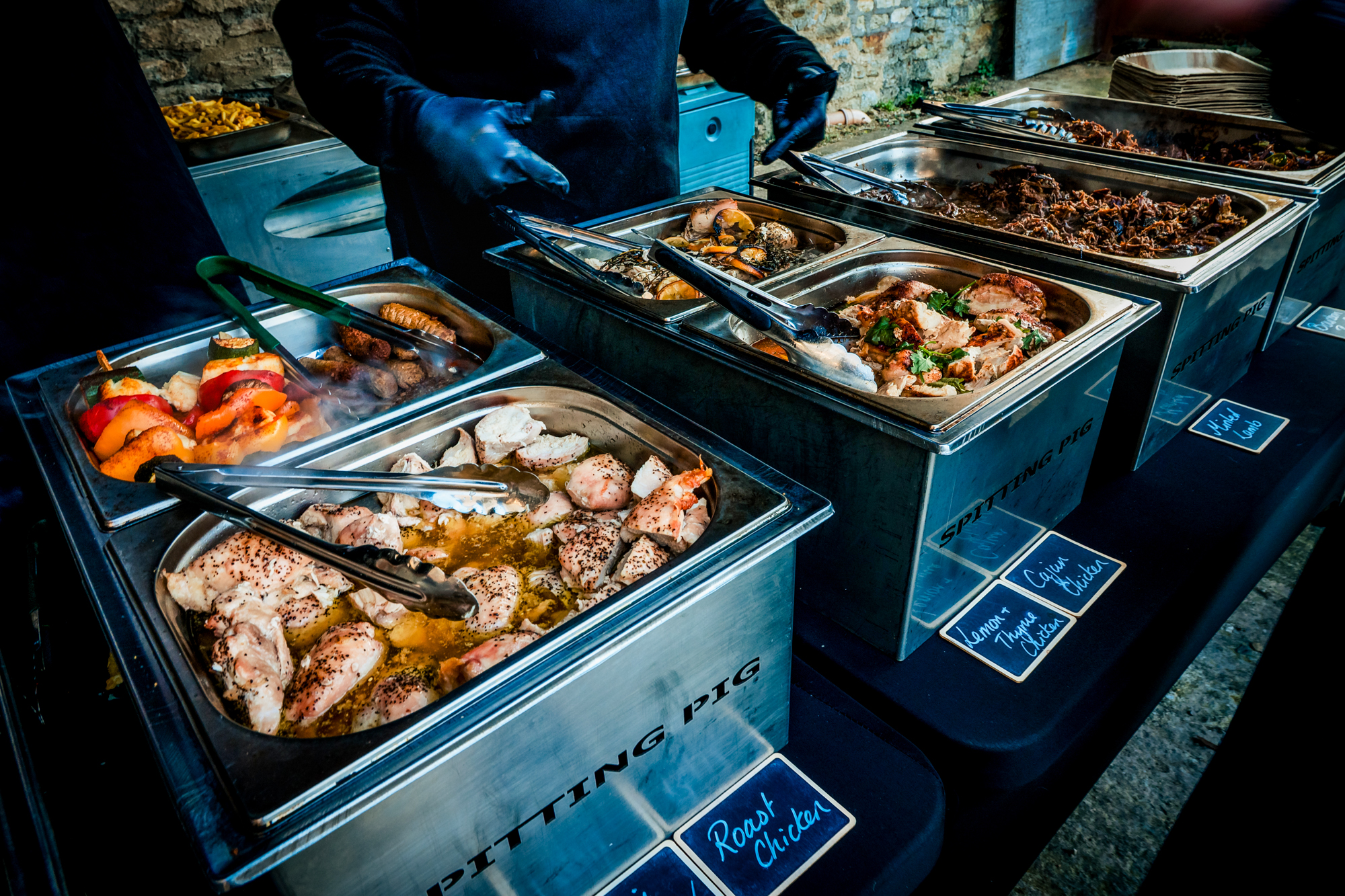 Spitting Pig buffet served at the wedding with roast chicken, vegetables, and pulled pork.
