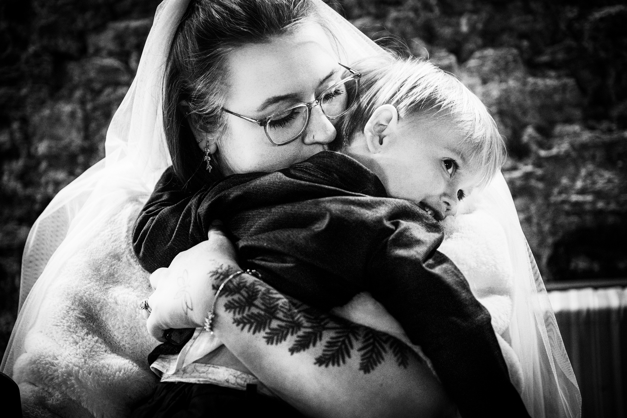 Nat hugs Theo close during a quiet moment after the ceremony.