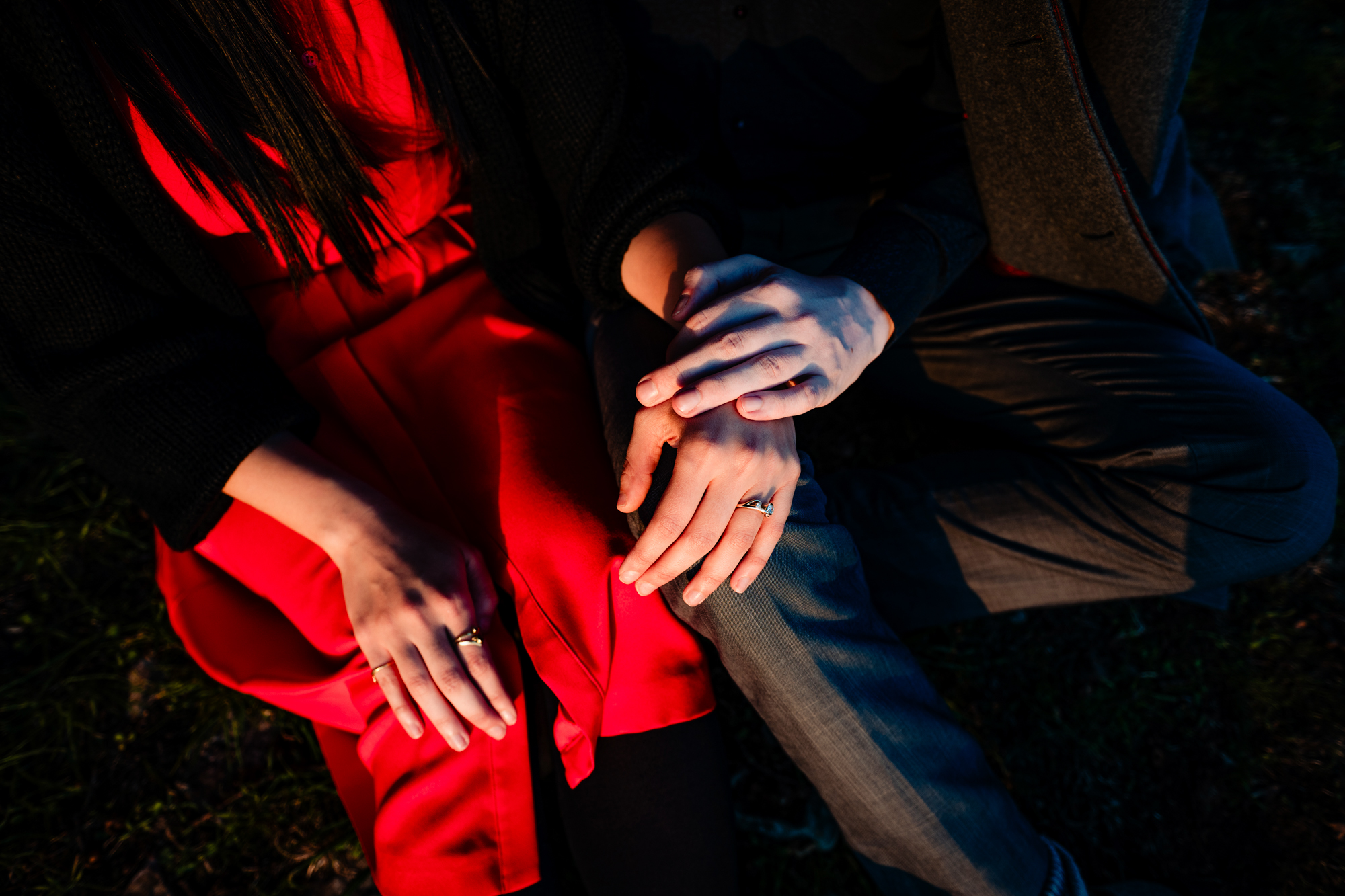 Close-up of clasped hands and engagement rings during Clifton evening couple session.