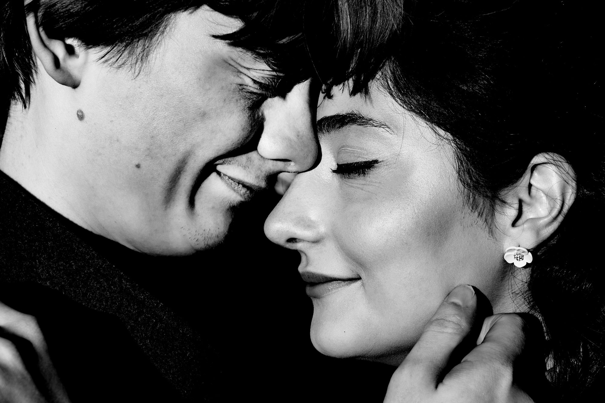 Black and white close-up of couple touching foreheads during romantic Clifton engagement session.
