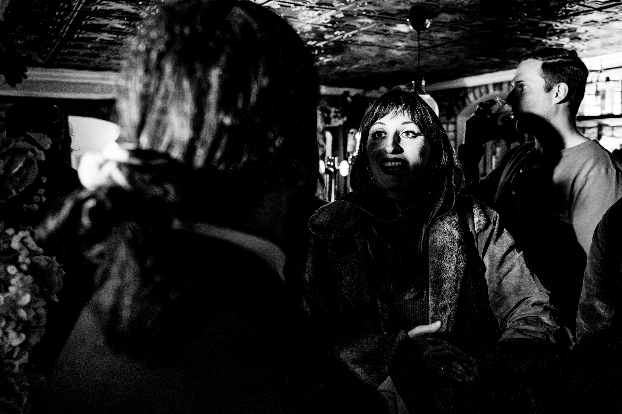 Wedding guest speaking in dramatic light at Racks Bristol.