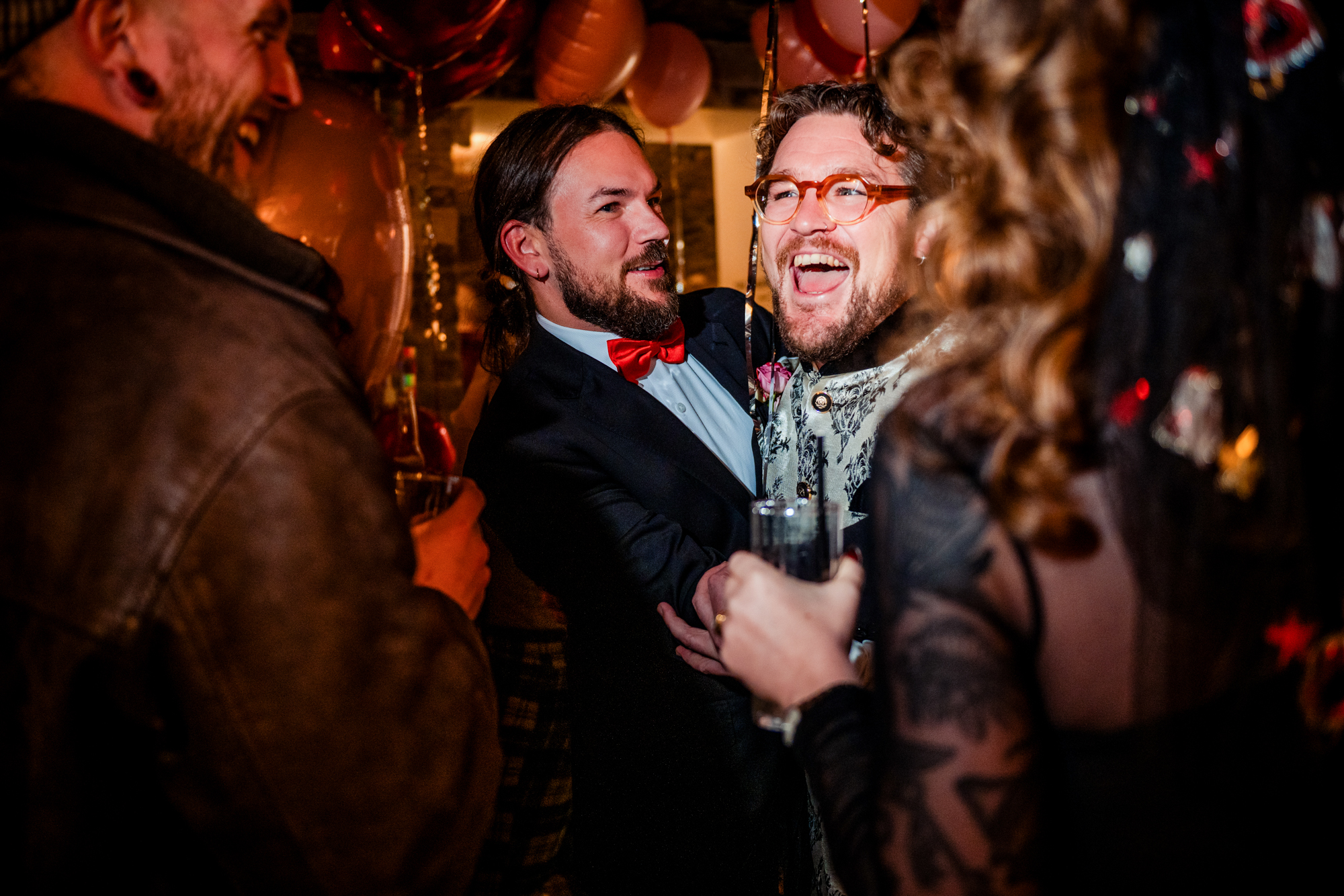 Guests laughing together under heart balloons in the Playroom at Racks Bristol.