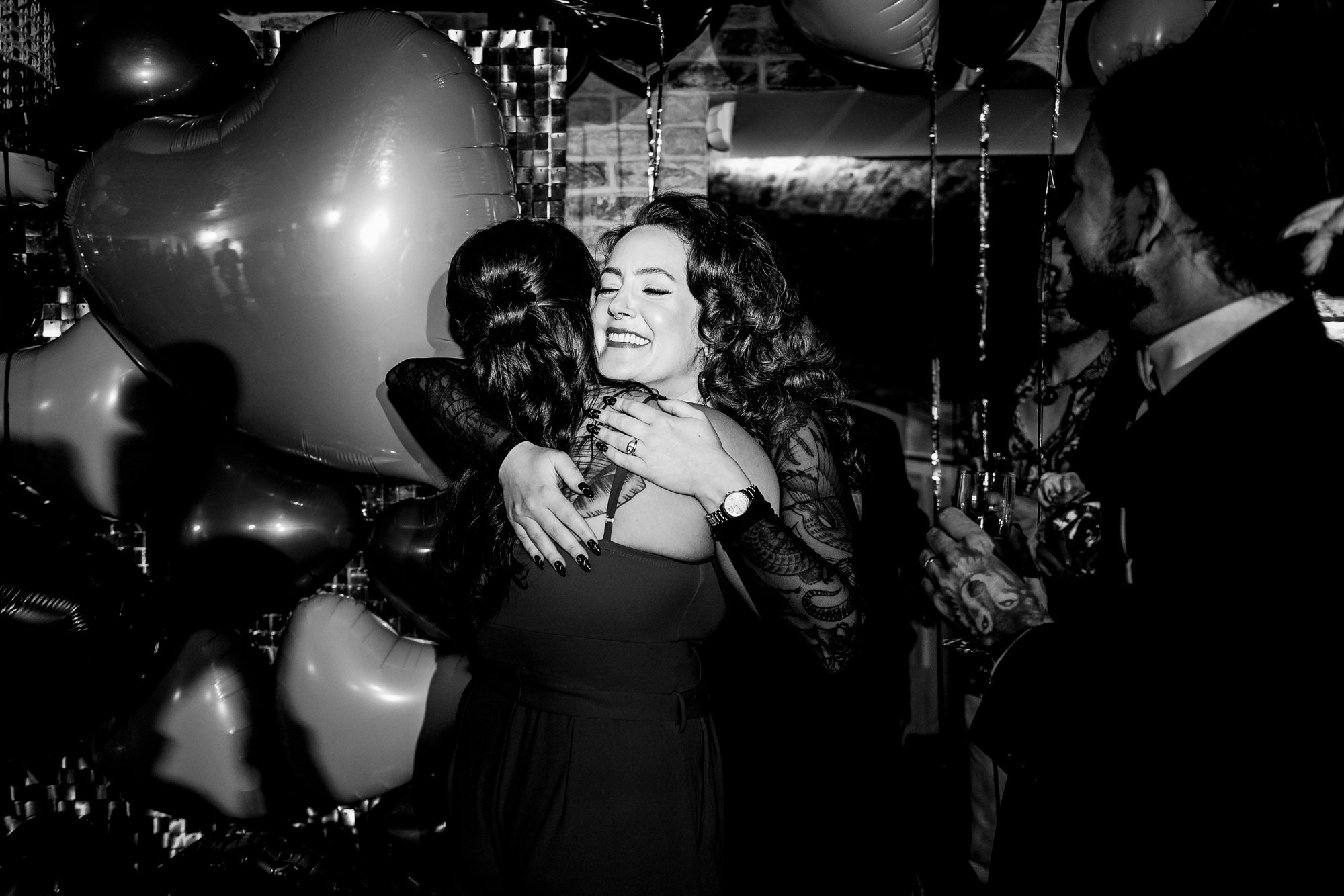 Bride and a guest hugging warmly during the wedding party at Racks Bristol.