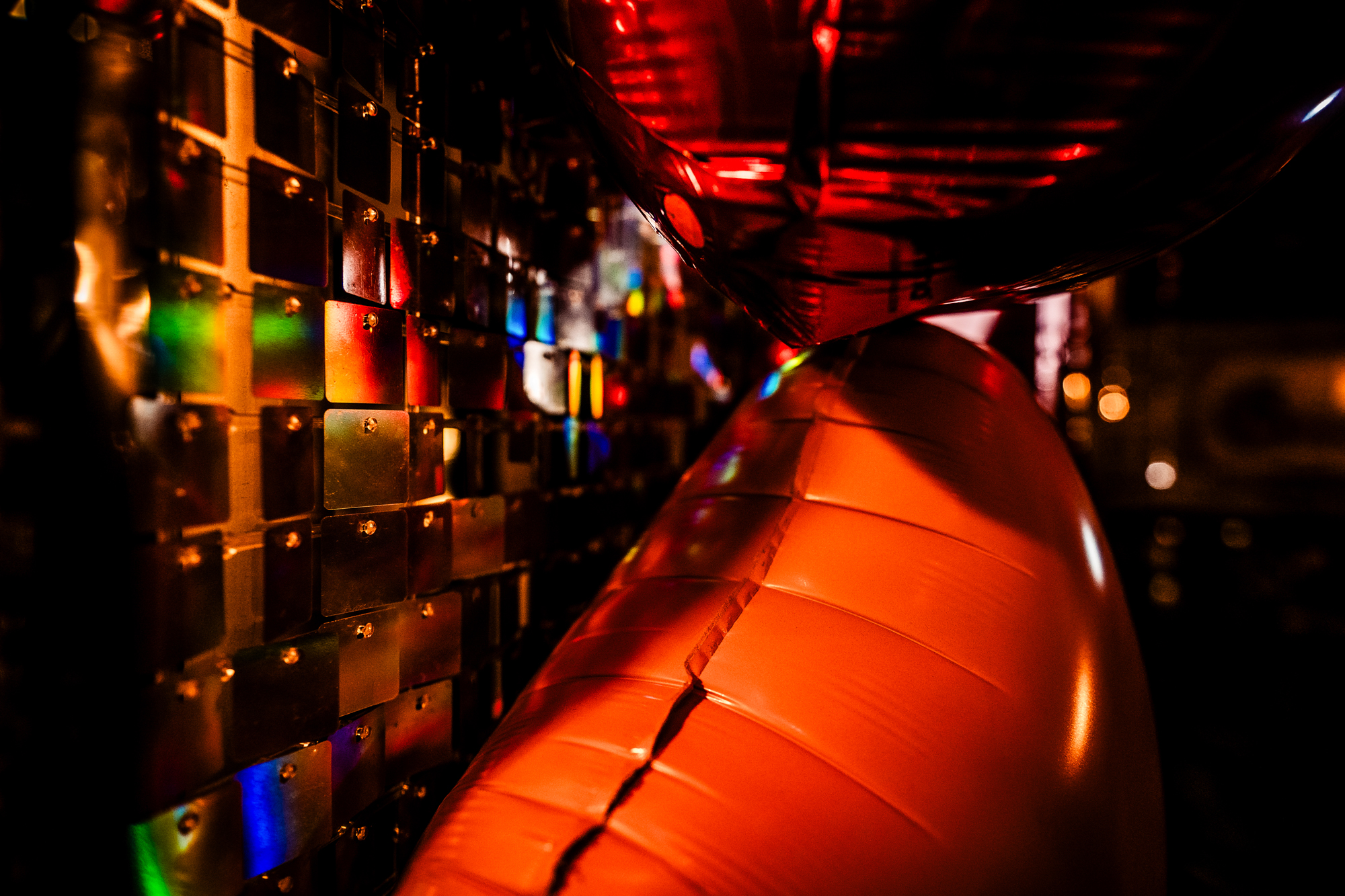 Close-up of heart balloons glowing beside the mirrored backdrop in the Playroom at Racks Bristol.