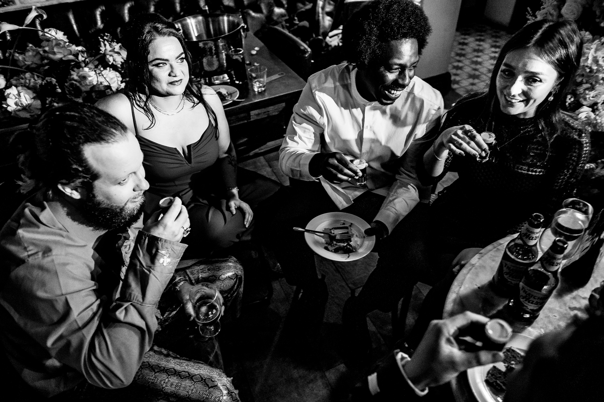 Friends laughing together over cake and shots at Racks Bristol.