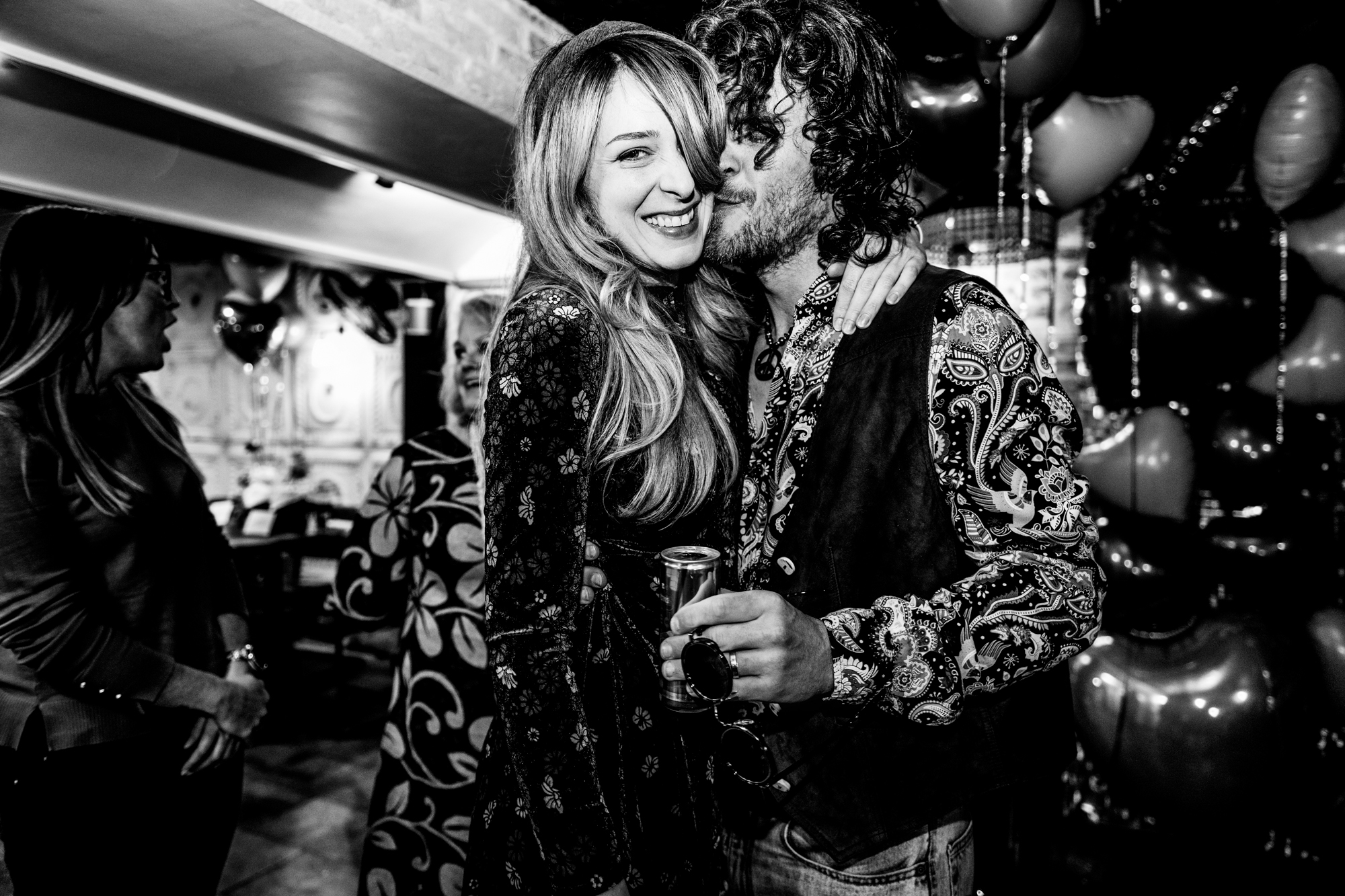 Guest kisses woman’s cheek during the wedding party in the Playroom at Racks Bristol.