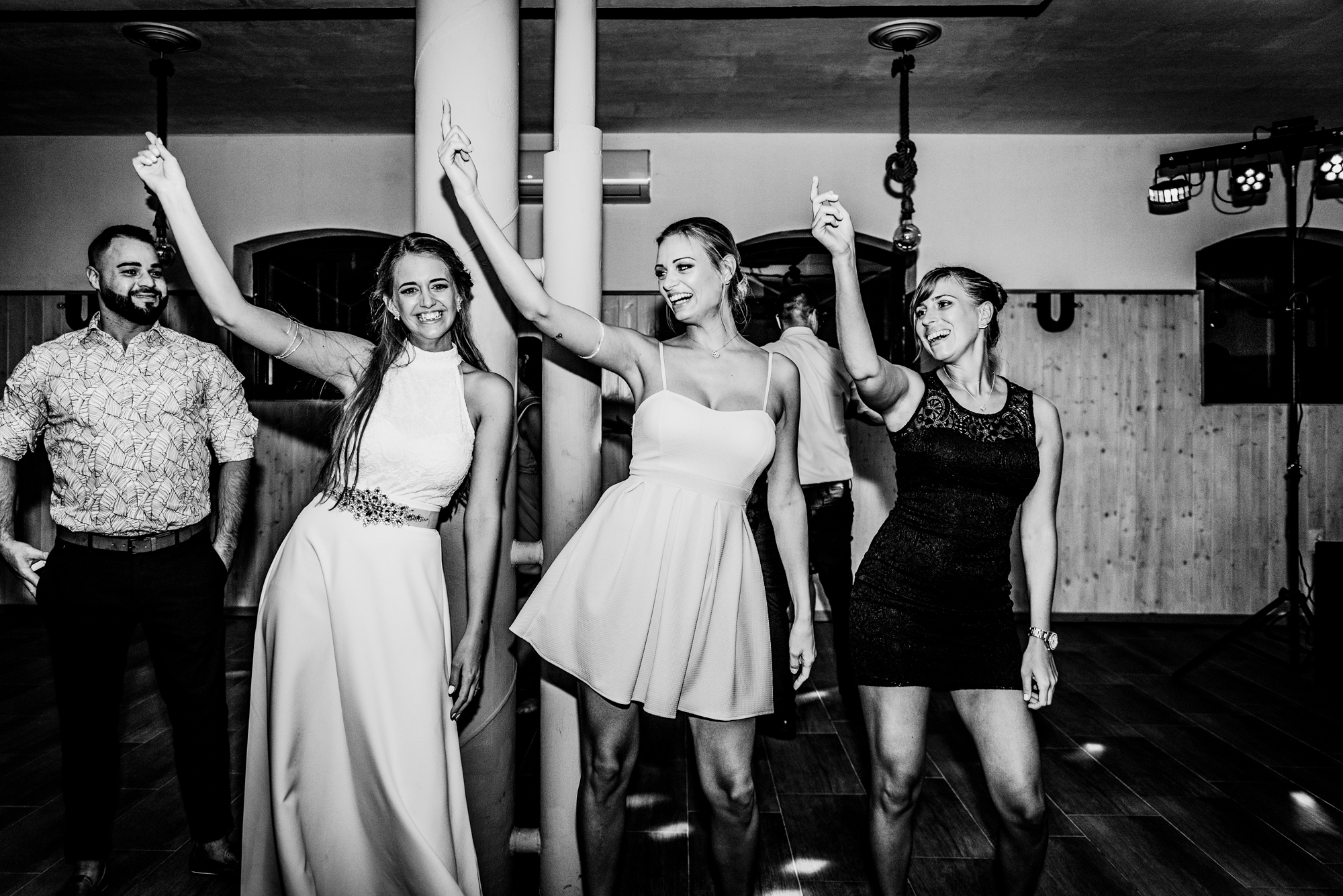 Bride and guests dancing together on the dance floor during lively Csillagkert wedding party in Hungary.