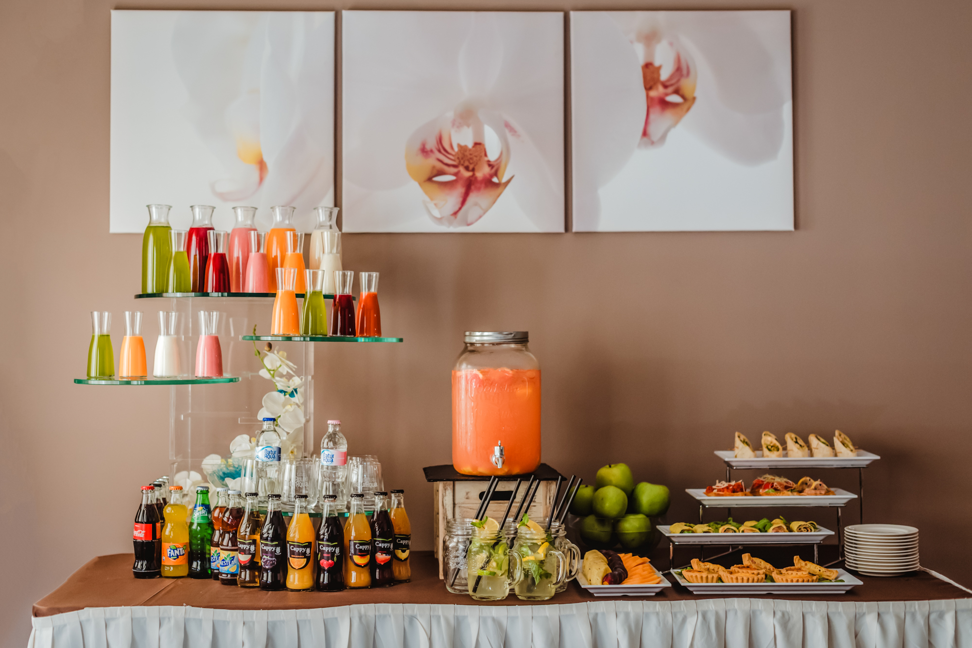 Hotel buffet table with colourful juices, cocktails, soft drinks, and canapé platters for an event reception at Rubin Wellness & Conference Hotel Budapest