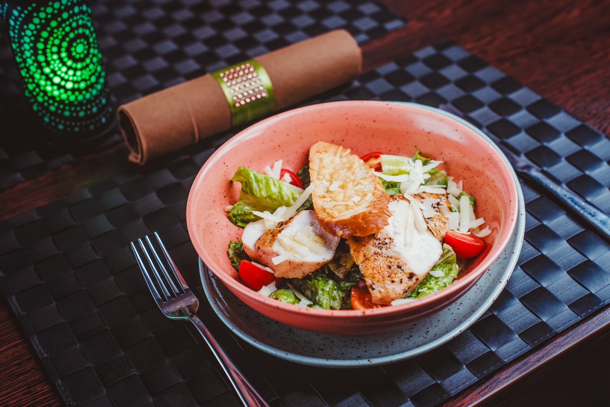 Grilled chicken Caesar salad with parmesan, croutons, and cherry tomatoes served in a ceramic bowl at Rubin Wellness & Conference Hotel Budapest.