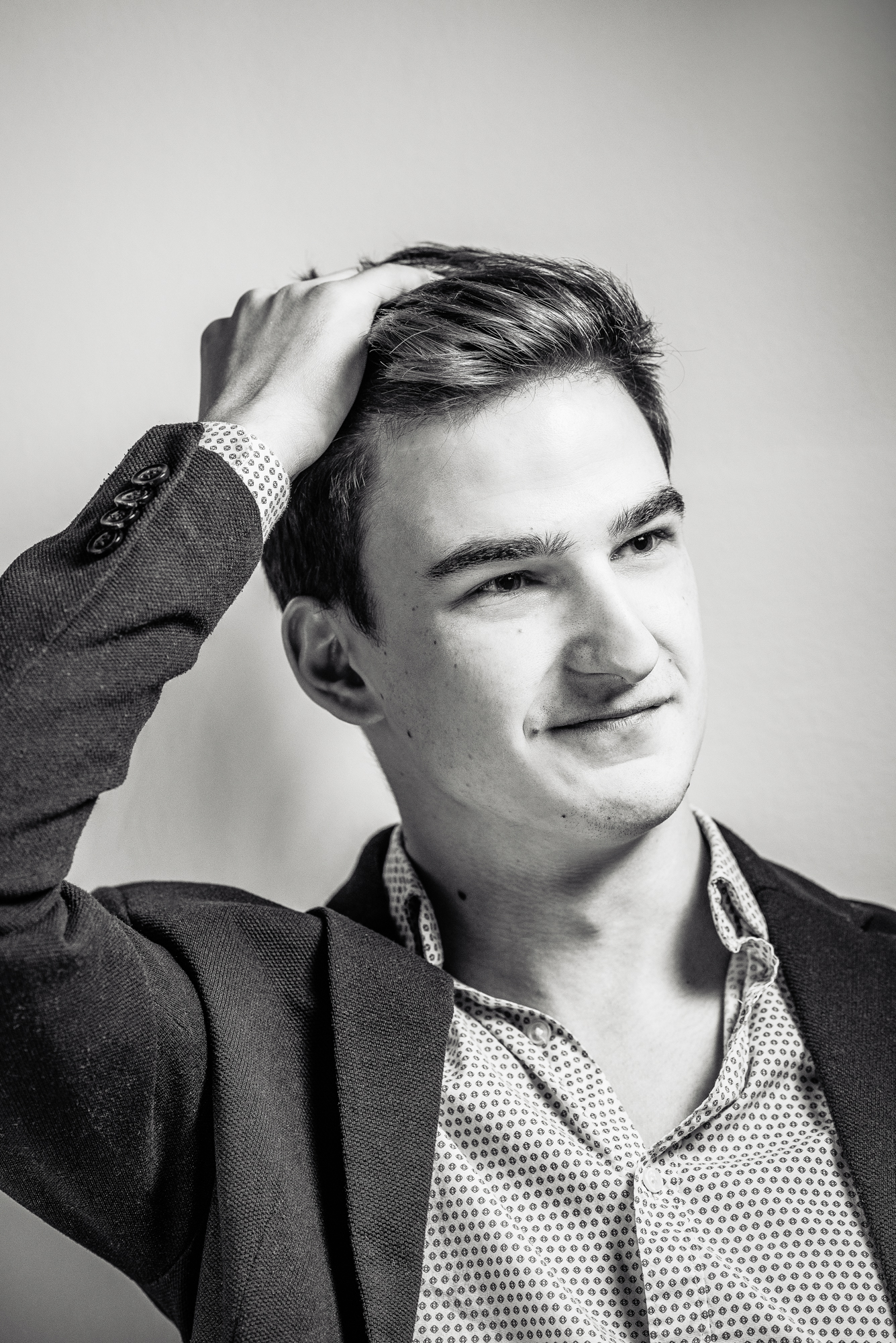 Black and white portrait of Ádám adjusting his hair during a Personal Branding Photoshoot Budapest.